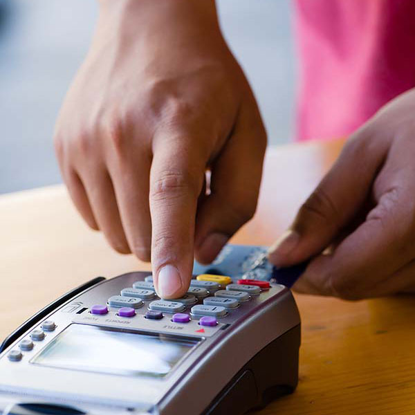 A person charging a credit card with chip reader. 